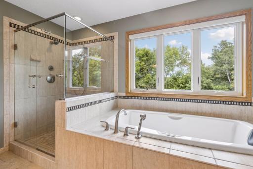 Settle in to a hot bath in the large soaker tub with window overlooking private backyard