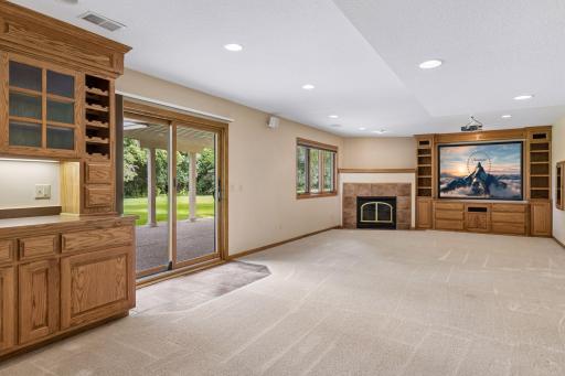Lower level family room boasts third fireplace