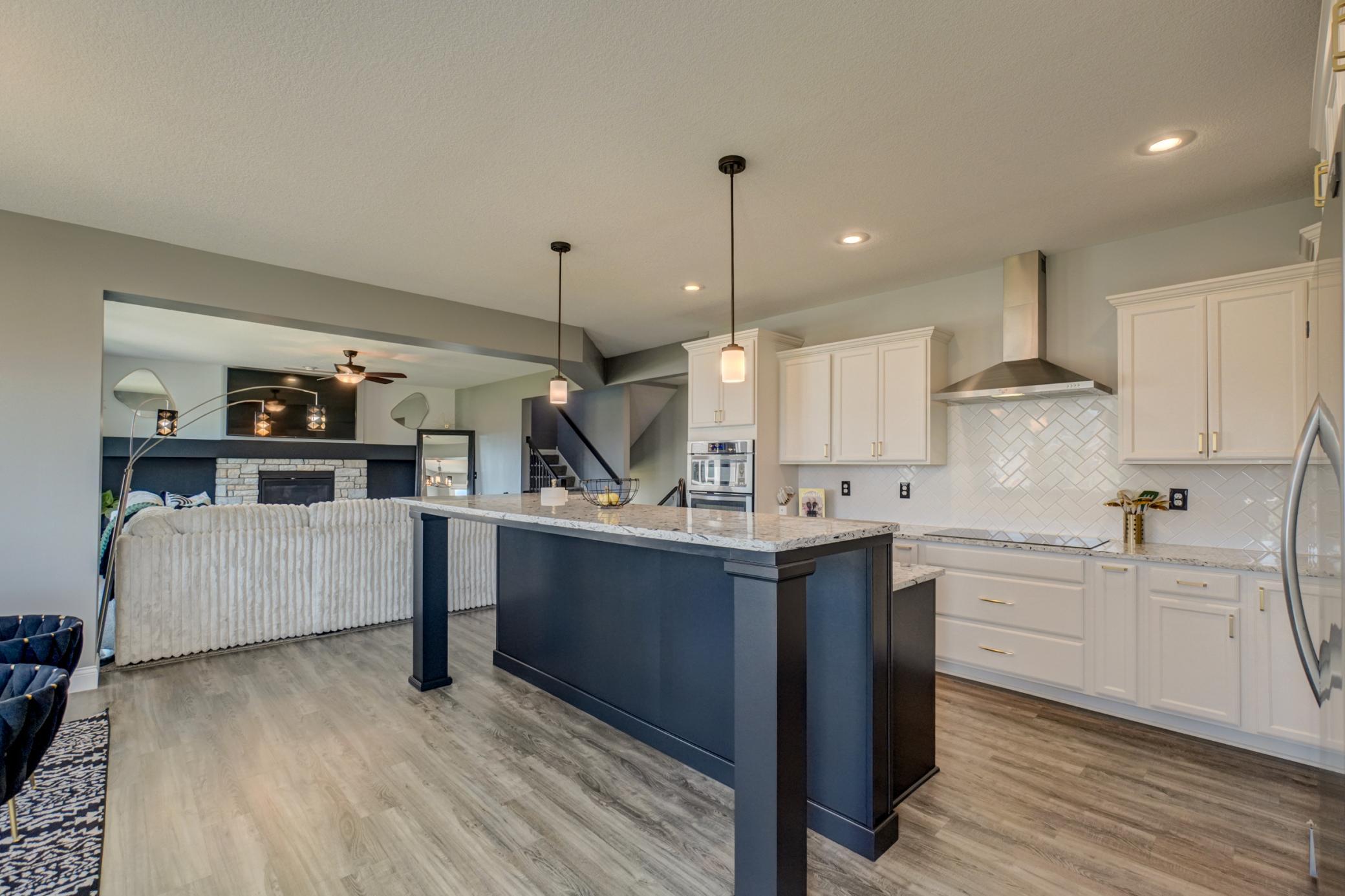 An oversized center island offers the perfect place for meal prep, casual dining, and entertaining