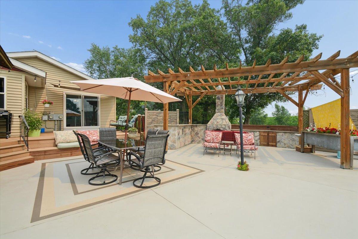 Large outdoor entertainment area with wooden pergola