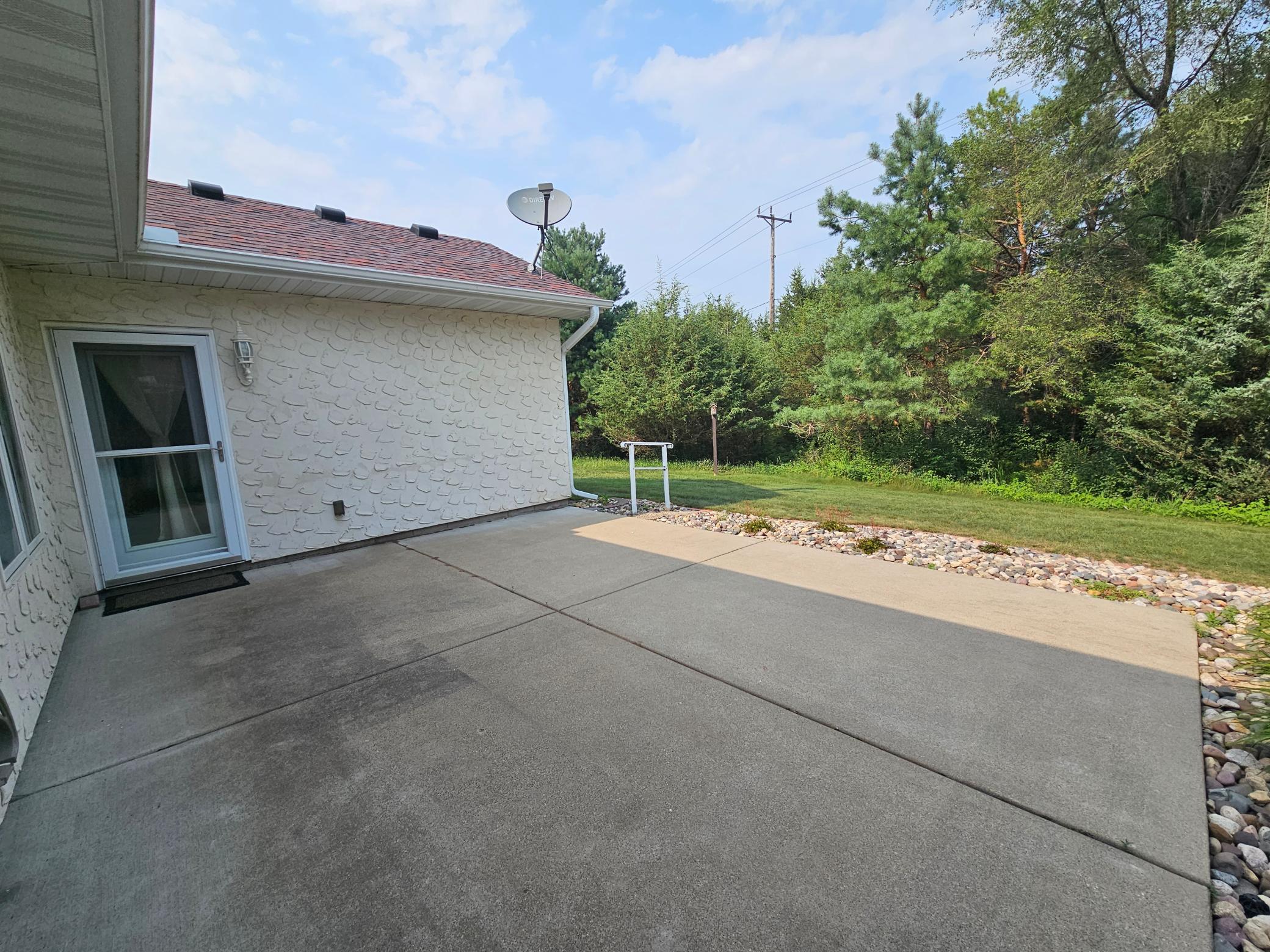 Back large patio area with private backyard.