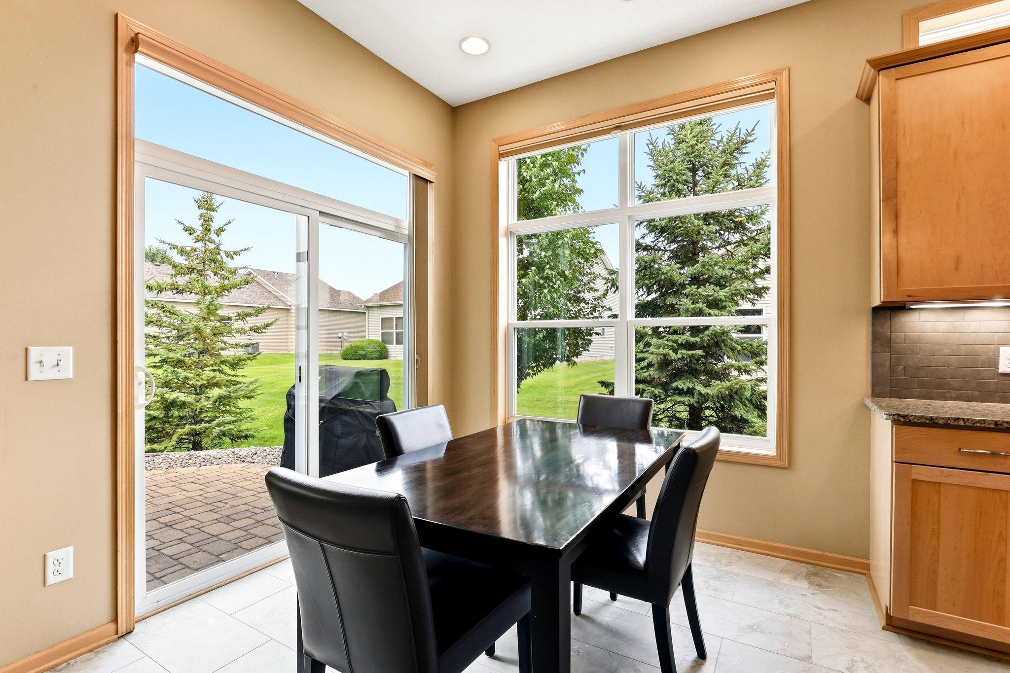 Informal dining space opens directly to the paver patio, creating an easy indoor-outdoor flow. Perfect for casual meals, summer grilling, and effortless entertaining.