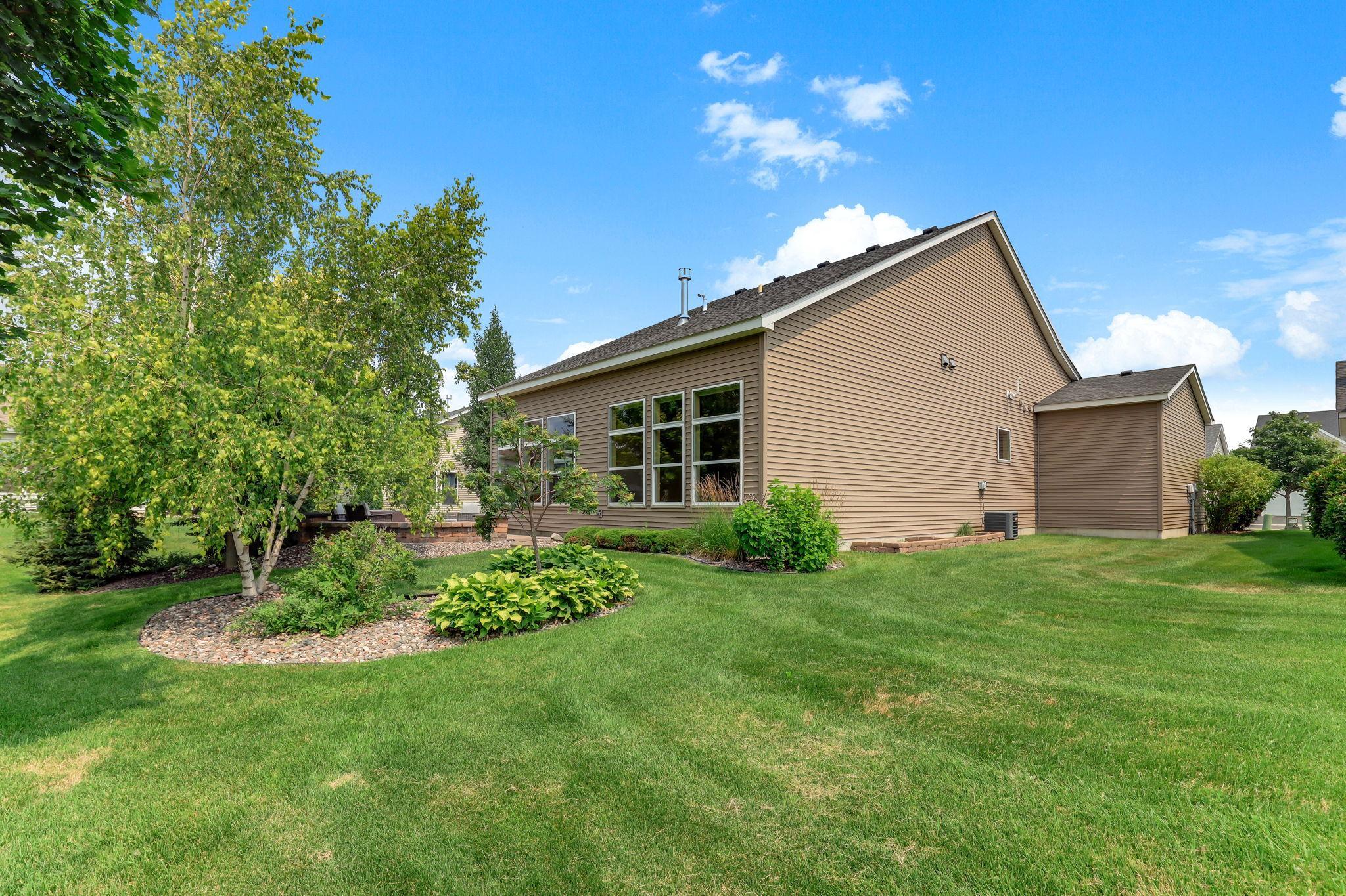 Landscaping features well-kept greenery and thoughtful plantings that enhance curb appeal.