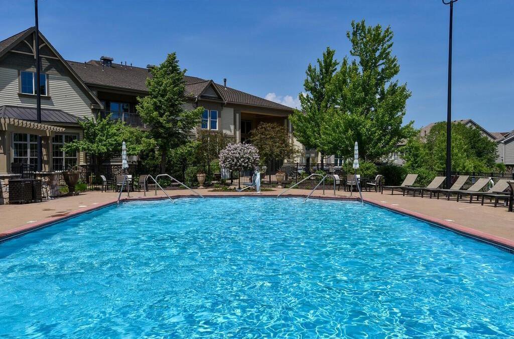Beautiful outdoor pool with spacious deck and resort-style seating for warm-weather relaxation.