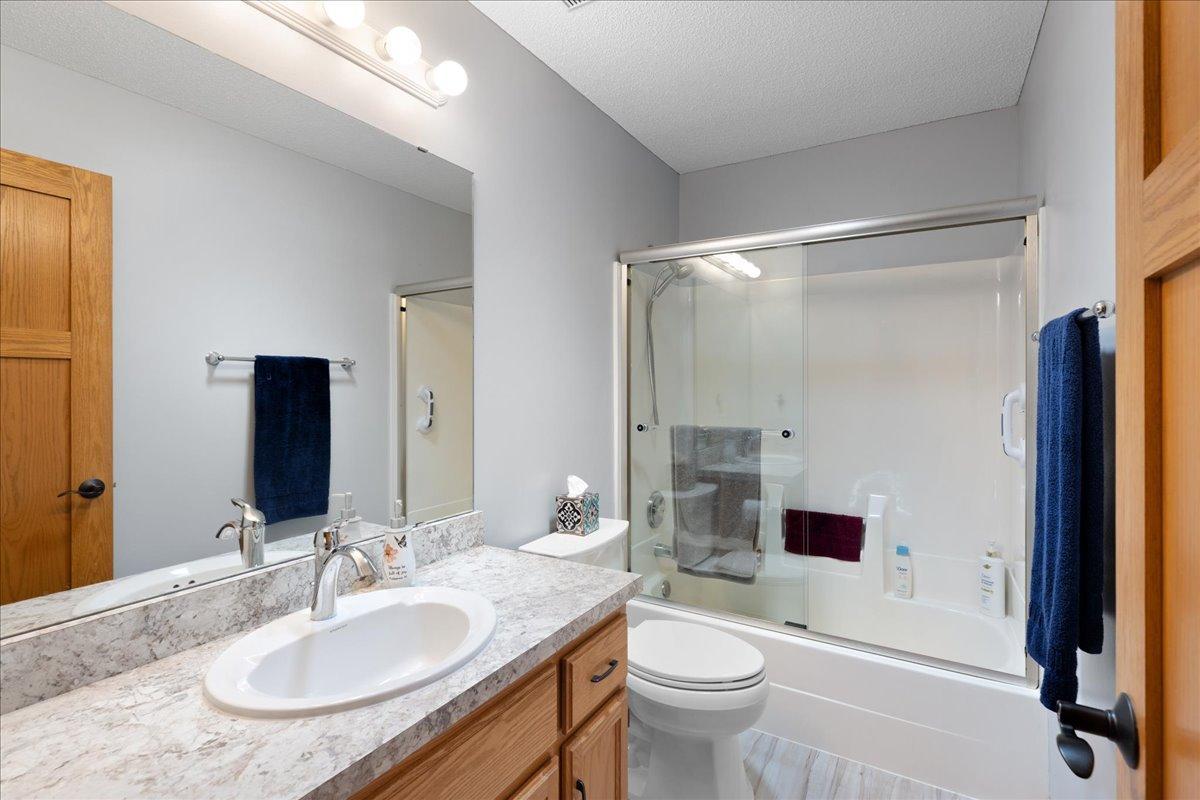 Upper level full guest bathroom with new glass shower door