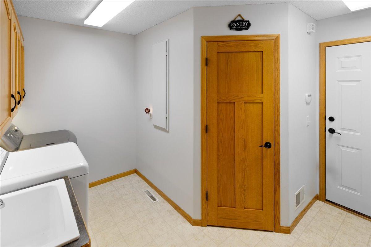 Main floor laundry with large pantry closet and easy access to garage