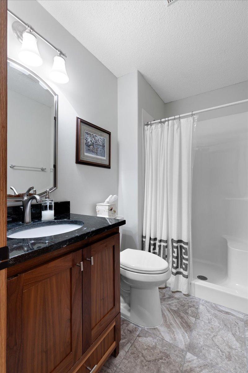 Main floor bathroom with elevated granite counter and vanity