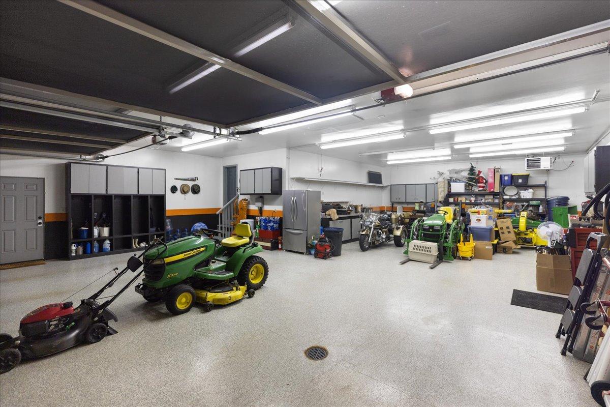 Two 18' wide insulated garage doors cover this heated garage with epoxy floors and floor drains