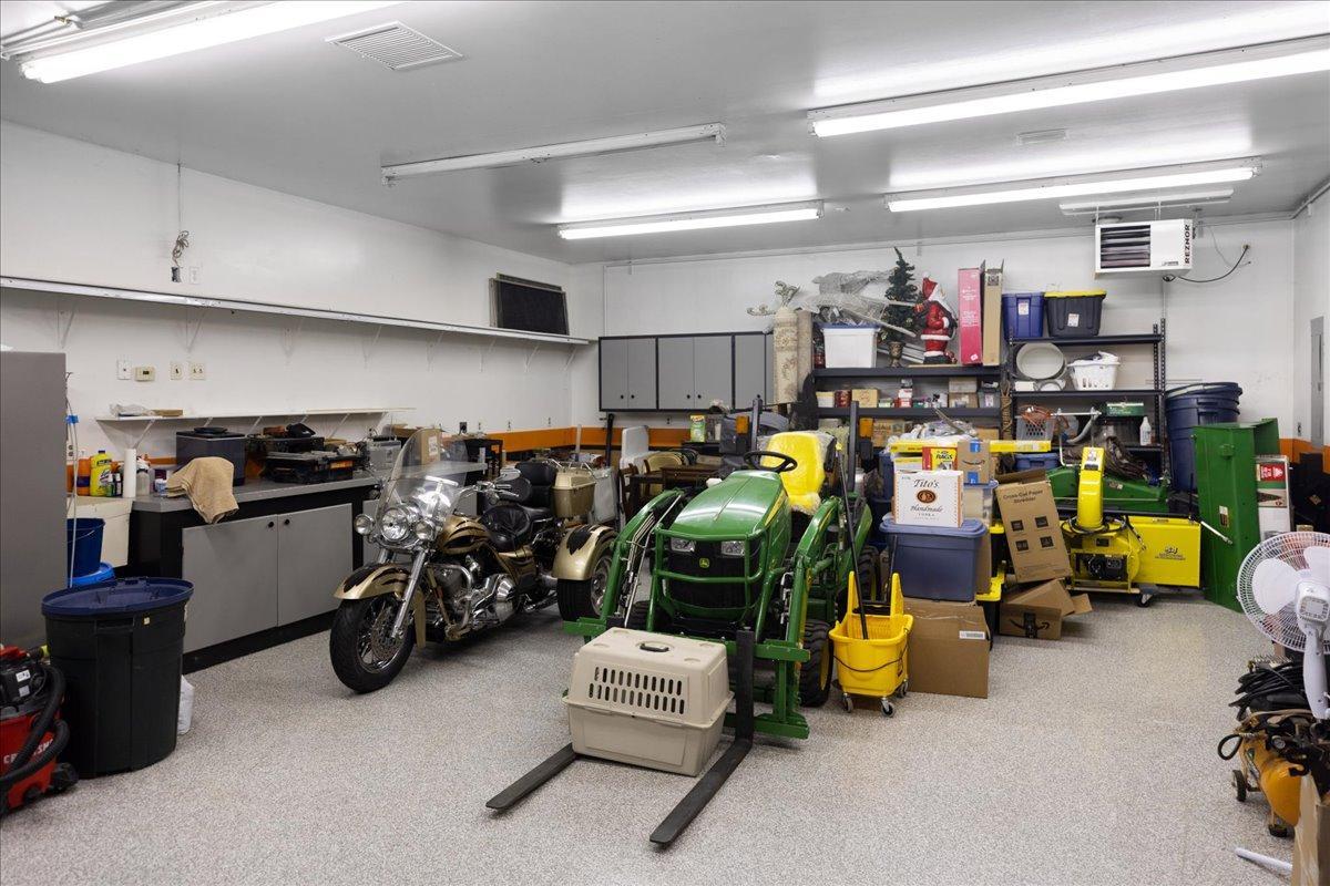 Tandem two car garage with workbenches, mop sink with hot and cold water lines. Plus air pressure lines along walls too.