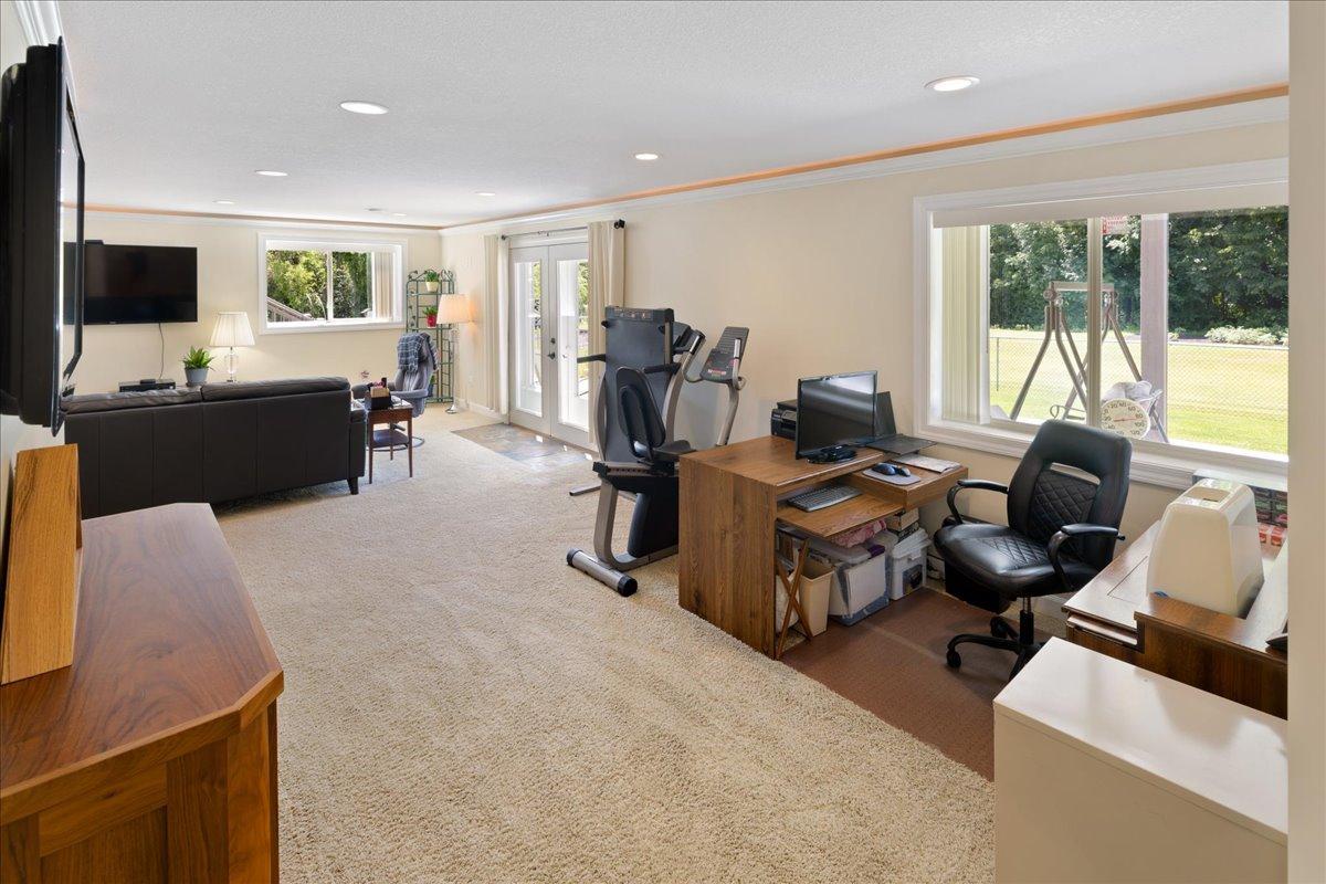 large windows overlooking the backyard and covered patio areas