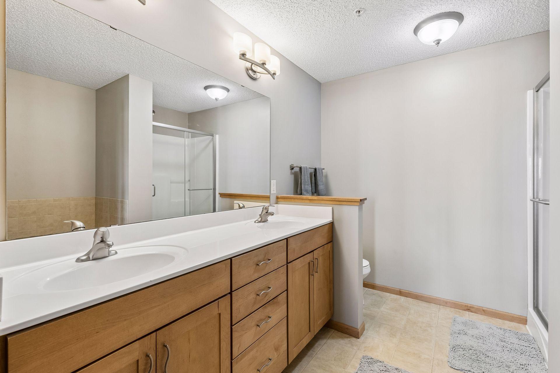 Double sinks with your vanity that has a nice amount of cabinet space.