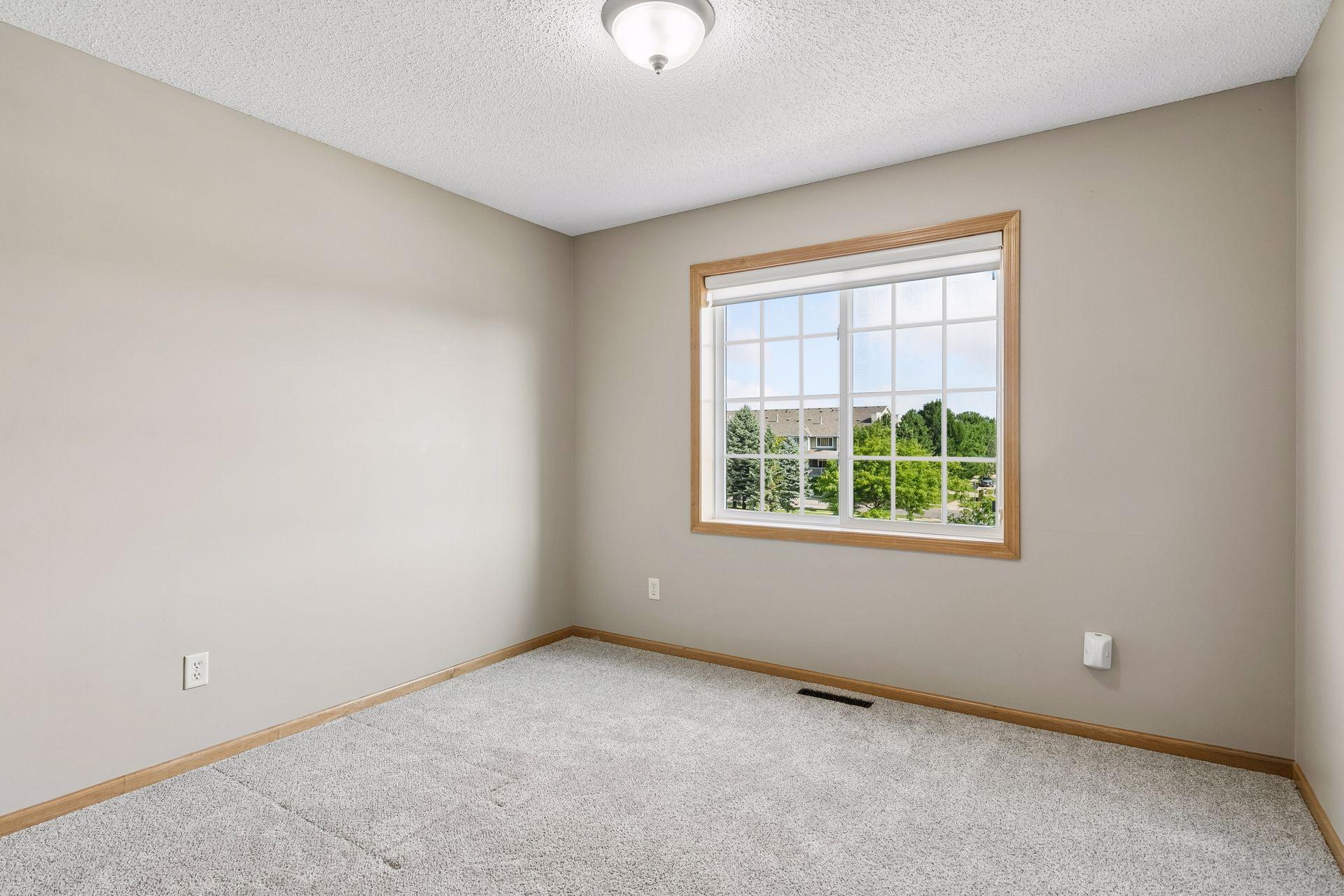 Another bedroom that is filled with natural light.