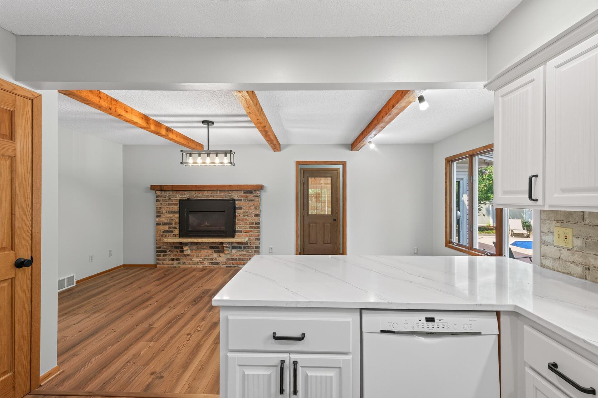 The kitchen adjoins the informal dining room/den area with a cozy gas fireplace!