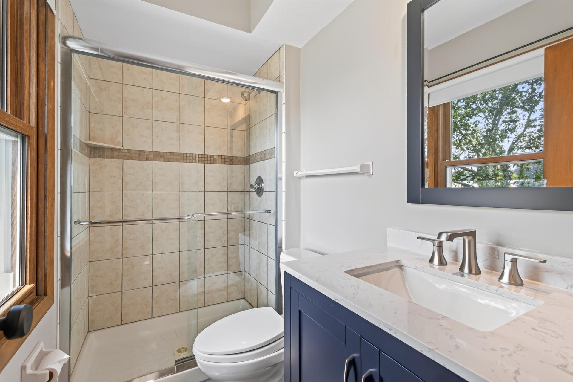 Private primary bathroom suite with new vanity/sink and countertop, and recently updated shower!