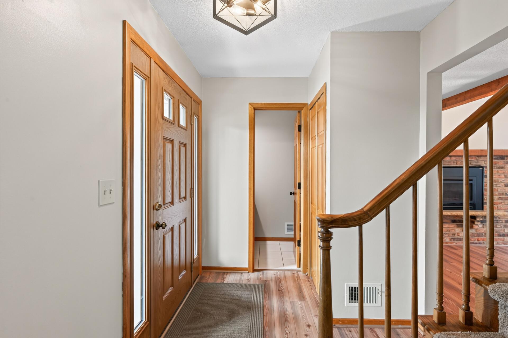 Inviting foyer area of the home with new plank flooring and fresh paint!