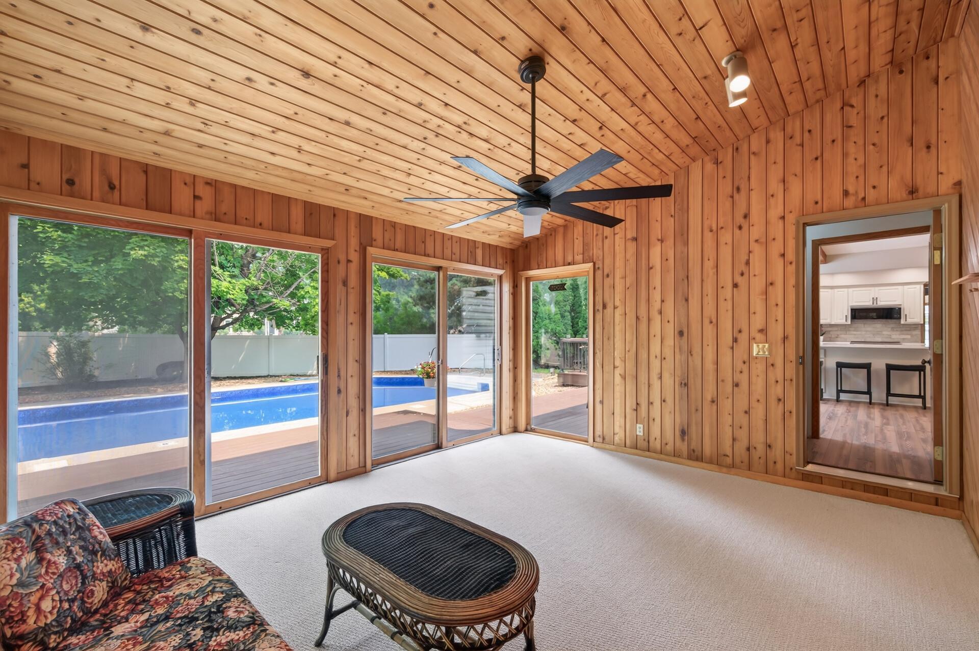 Fantastic main level three season porch with easy access to the backyard pool!