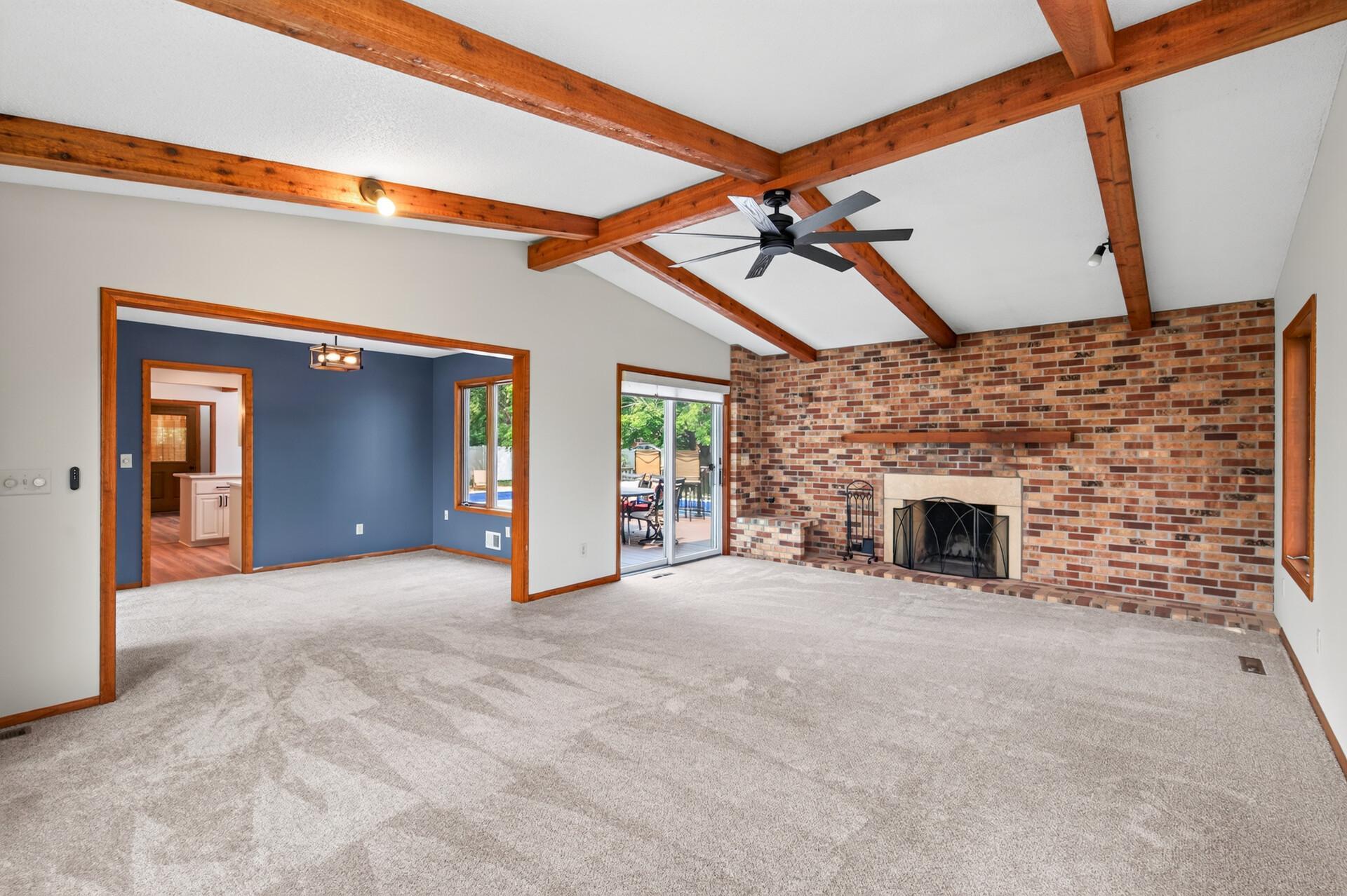 Spacious family room/great room that adjoins the living room and dining room with direct access to the amazing backyard and inground pool!