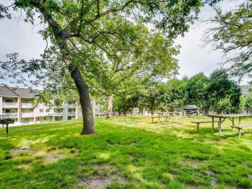 There are picnic tables and grills next to the pool for residents use.