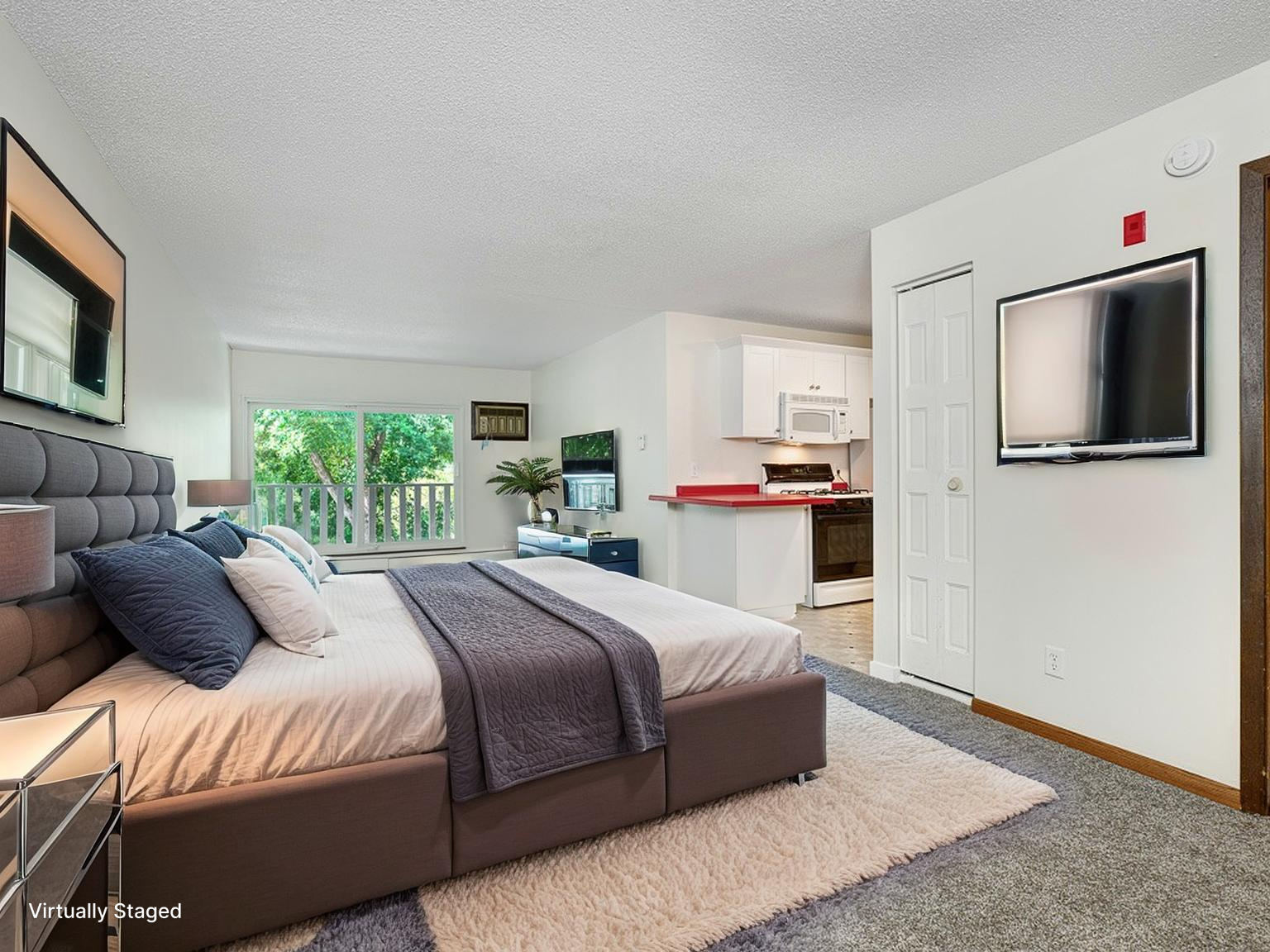 This studio has brand new carpet & entryway vinyl. Virtually staged photo.