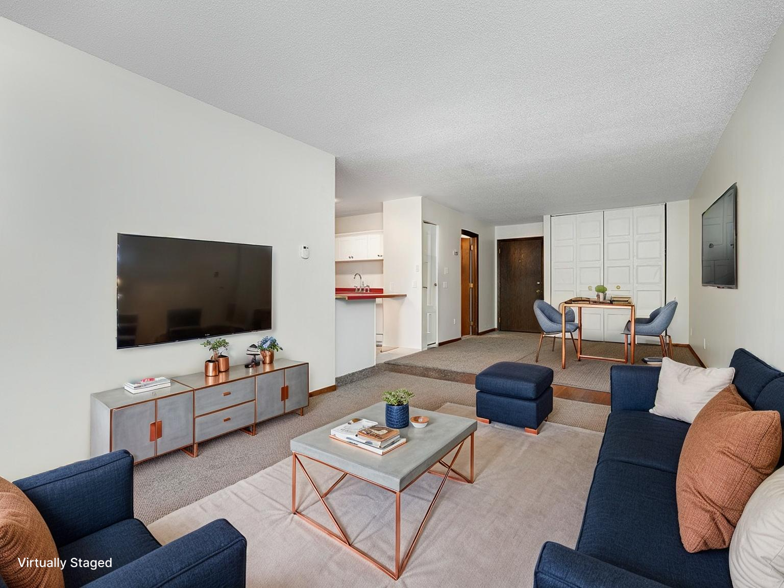 The bedroom & living room are separated by a small step down. Virtually staged photo.