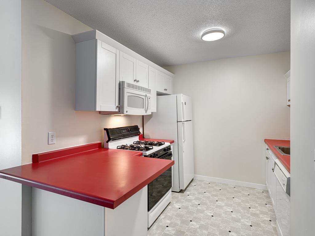 The kitchen was updated with white cabinetry & appliances.
