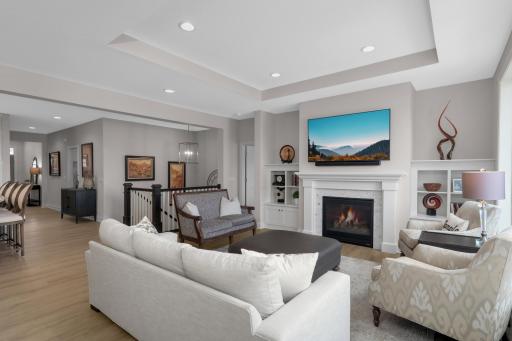 Living room has built in cabinets and vaulted ceiling.