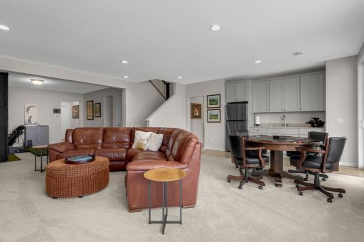 Lower level entertaining space with wet bar and ample cabinet space.