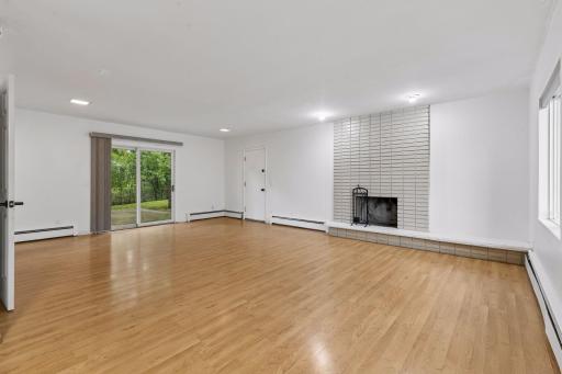Expansive main floor family room with brick wood burning fireplace and walkout to the backyard.