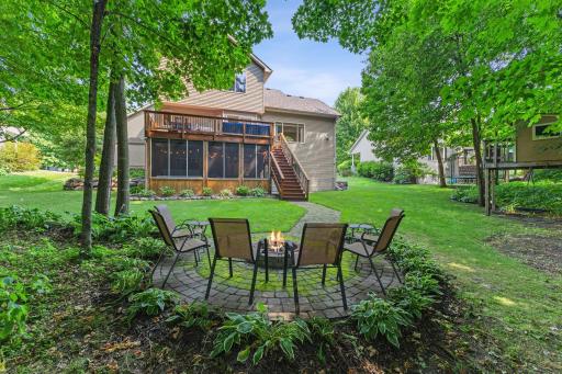 The backyard features a paver walkway to the paver firepit to enjoy cool MN evenings!