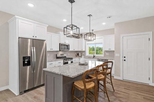 Kitchen view with countertop chairs.
