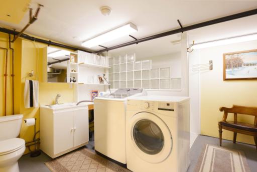 Lower level 1/2 Bath in Laundry area with walk-in shower behind the frosted block wall.