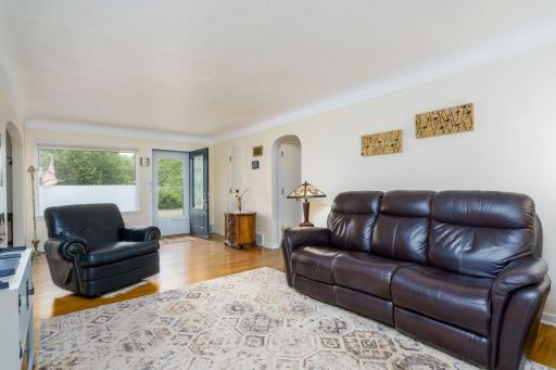 Large Living Room with beautiful floors and arched doorways