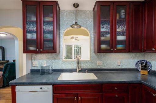 Several cabinets with rainglass doors and lots of counter space