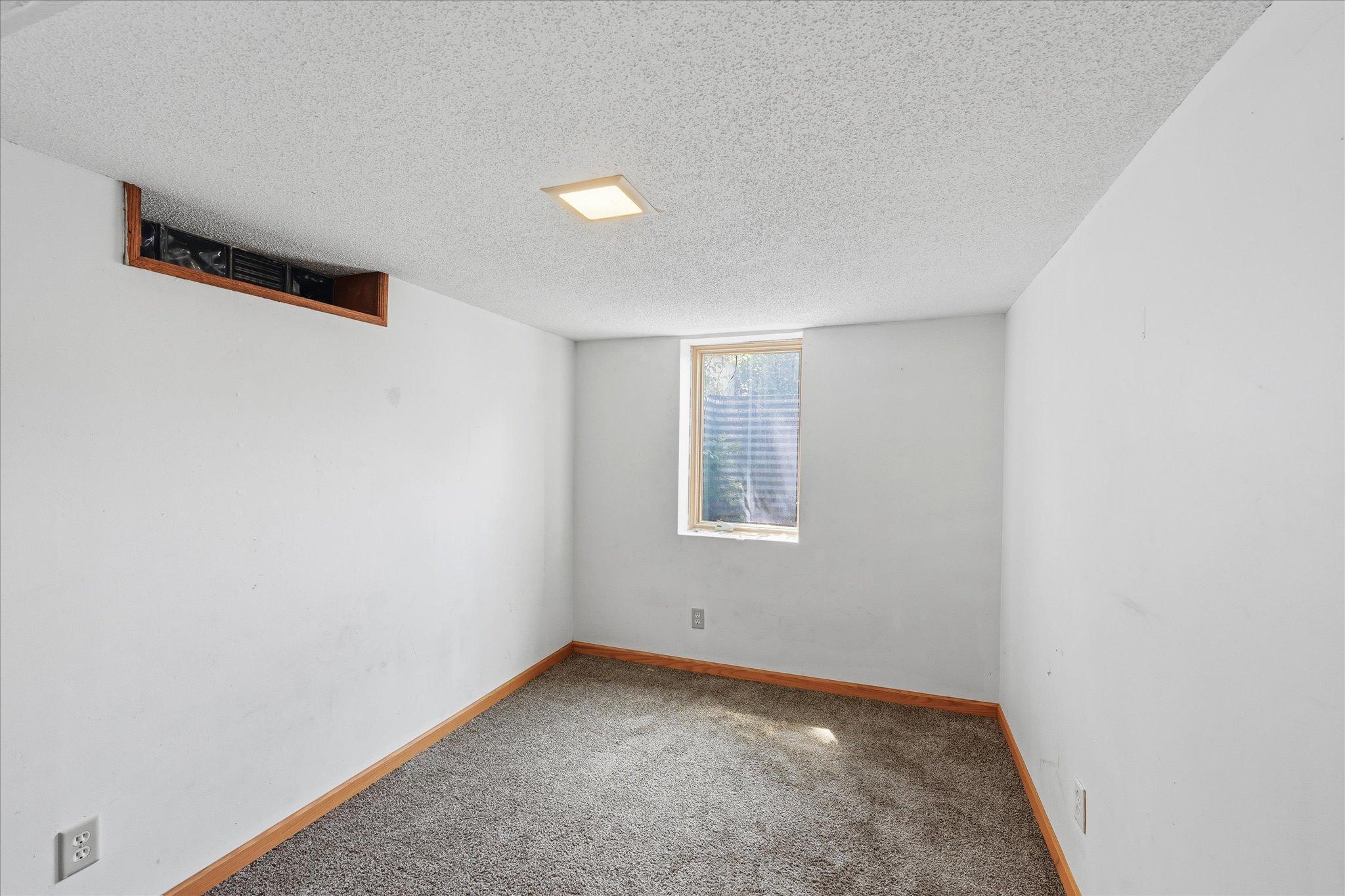 Lower level bedroom with egress window