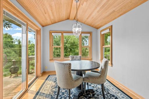 The sun room acts as the perfect dining space that walks out to the deck.