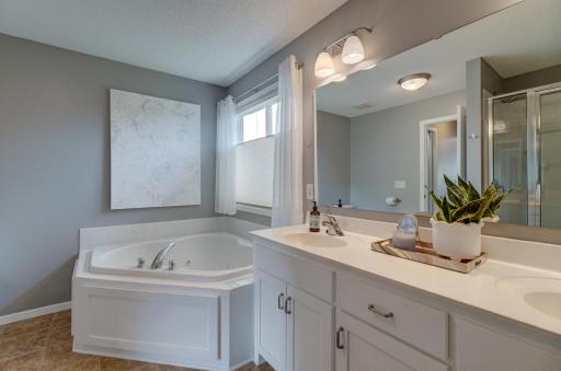 Indulge in the comfort of the spacious primary ensuite, featuring a large soaking tub and a serene atmosphere!