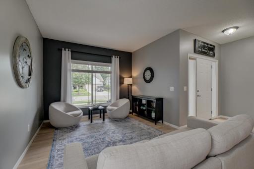 The spacious front living room welcomes you with beautiful natural light