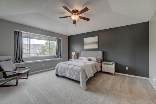 The beautiful primary suite provides a relaxing retreat with a built-in window seat and bright, airy surroundings!
