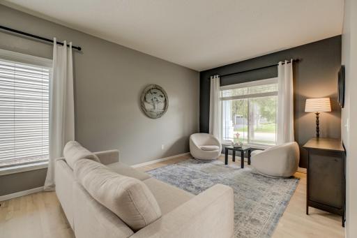 A charming front living room provides the perfect space for conversation, reading, or relaxing!