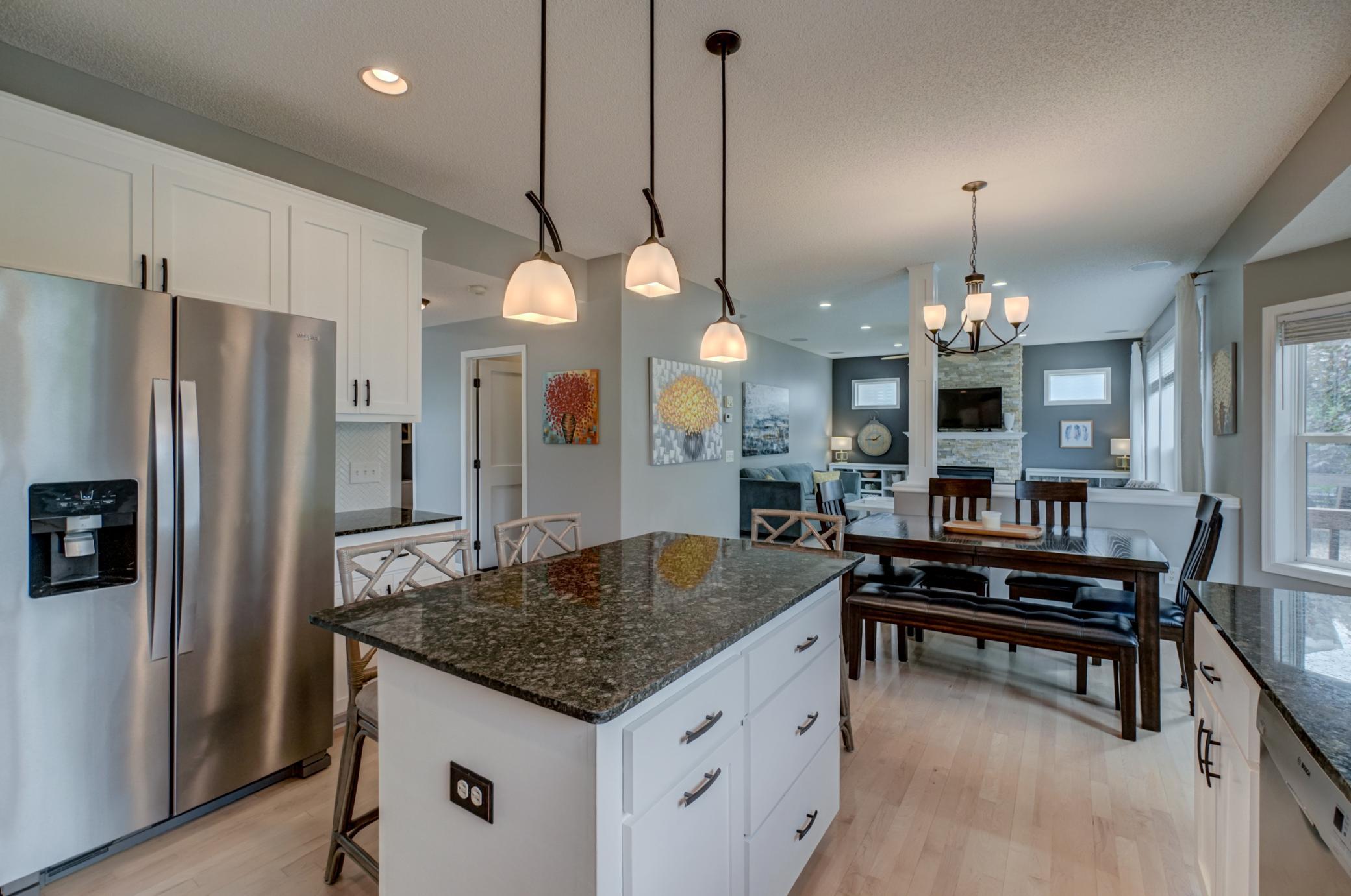The oversized center island provides plenty of space for gathering, entertaining, and connecting with the adjacent great room