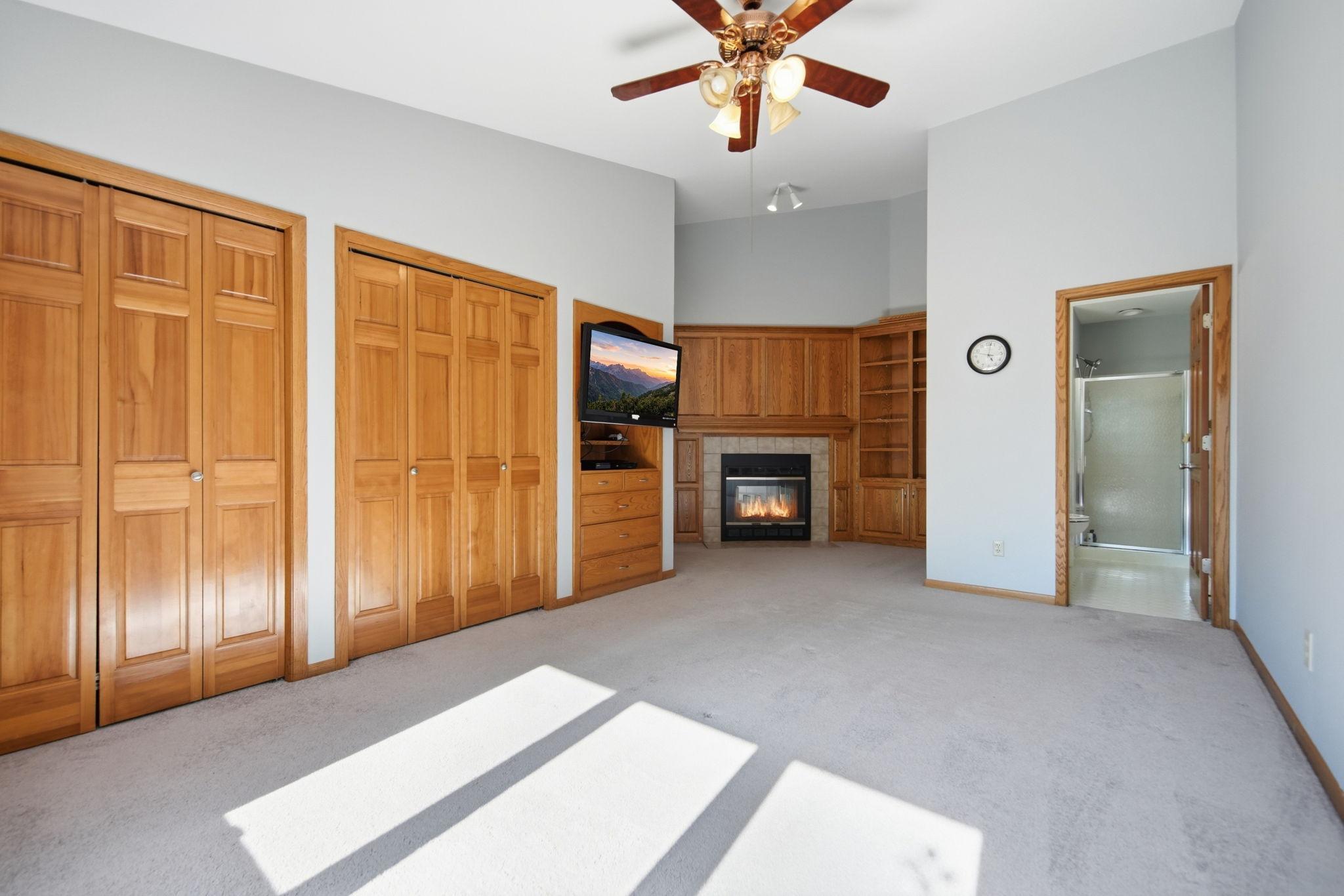 Upstairs, you'll find two spacious bedrooms, including a stunning owner's suite featuring custom built-ins, a cozy fireplace, dual closets, and a private ensuite bathroom.