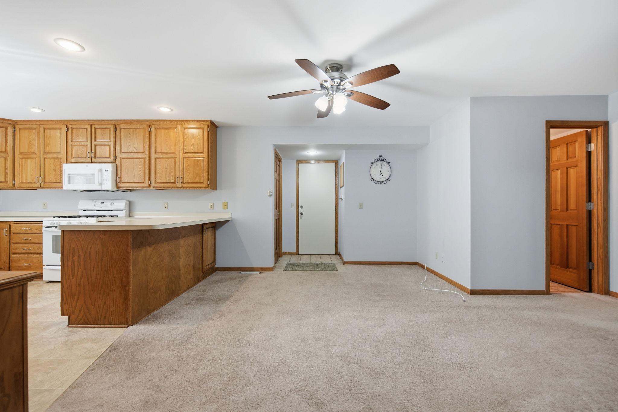 Everyday living is effortless with the attached garage entry, neighboring coat closet, and conveniently located powder room just off the kitchen and dining area.