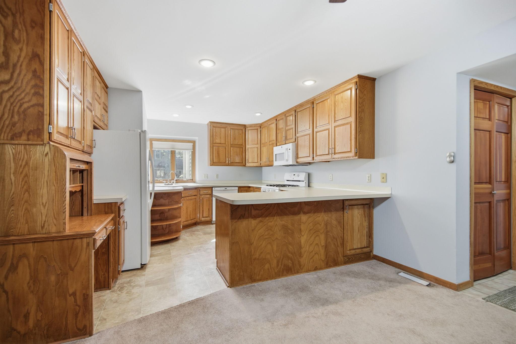 Rich real wood cabinetry provides exceptional upper and lower storage, while vast counter space makes cooking and entertaining a breeze.