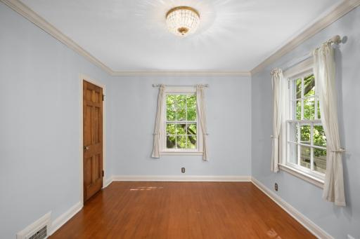 The second of four bedrooms on this level has refinished hardwood floors and a walk-in closet.