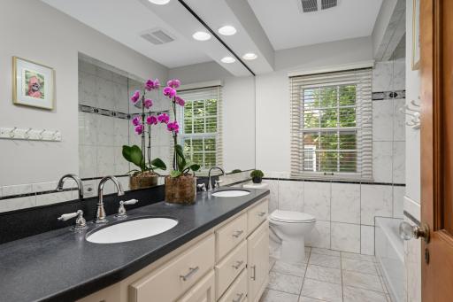 The shared full bathroom with dual vanity.