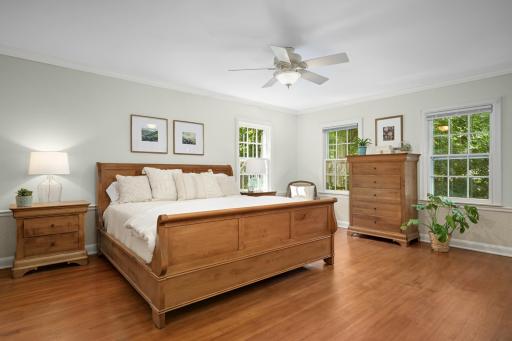 Large primary bedroom with sun-filled windows.