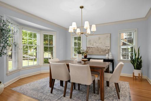Formal dining room with sunny bay window.