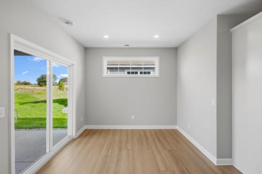 Situated in front of glass sliders, this dining room provides the perfect place for sun-dappled meals that can venture out to the covered patio.