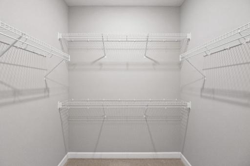 Low and high shelving in the oversized walk-in closet maximizes wardrobe organization and creates additional storage space