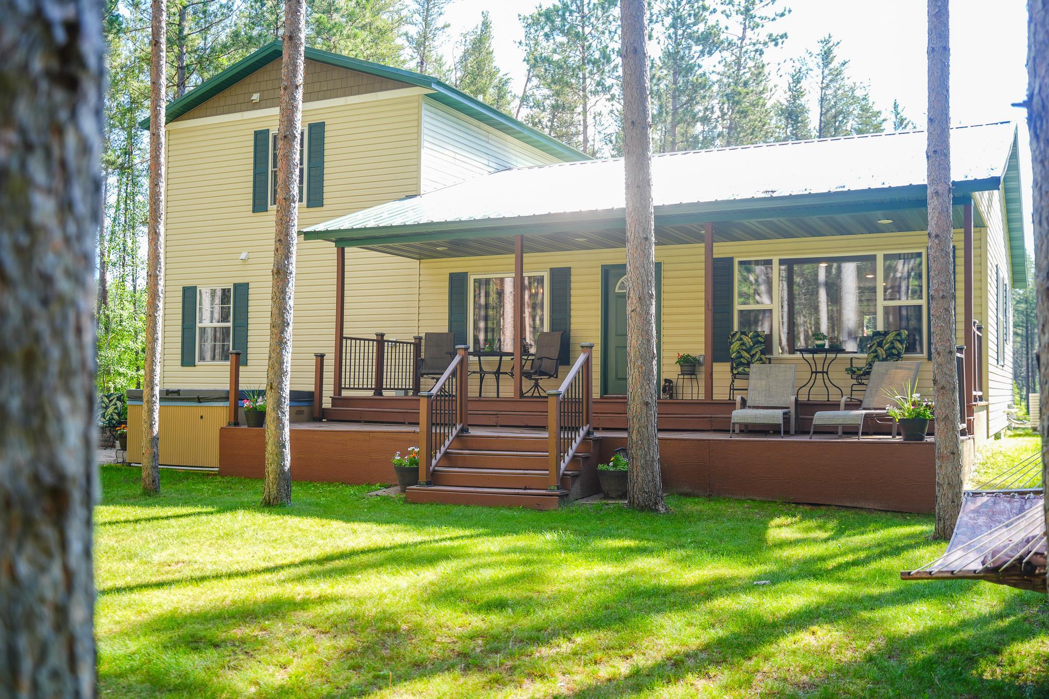 Back with Large Covered Deck & Patio with a Hot Tub